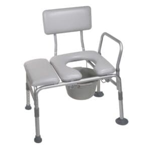A gray metal and padded shower chair with an open seat design, back support, and armrests. It includes a removable bucket underneath. The chair has adjustable legs with rubber tips for stability.