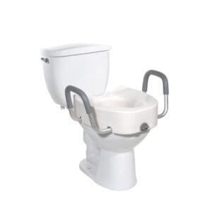 A white toilet with a raised seat and gray safety handles attached on either side, designed for accessibility and support. The tank is visible in the background.