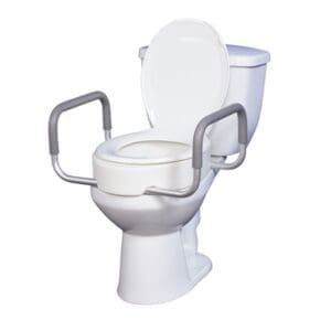 A white toilet with an elevated seat and gray safety rails on both sides. The lid is open, and the toilet is positioned on a plain white background.