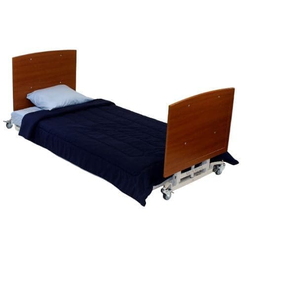A single hospital bed with a wooden headboard and footboard, equipped with wheels. It is made up with a dark blue blanket and a light blue pillow.