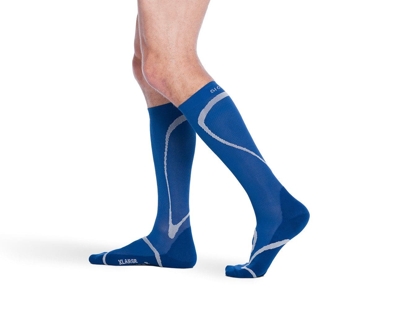 A person wearing blue knee-high compression socks with light gray accents, standing with one foot slightly forward on a white background.