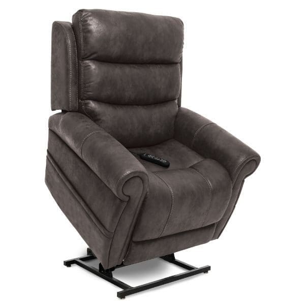 A dark gray, leather recliner chair with padded armrests and a footrest extended. It has a lift feature, shown slightly elevated with a remote control on the seat.