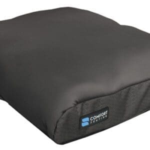 A black ergonomic seat cushion with a handle is displayed. It features a soft, contoured design with a Comfort Company logo on the corner.