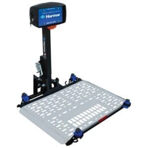 A Harmar mobility lift with a platform and a vertical support arm. The platform has perforated sections for grip, and adjustable clamps are visible at the corners. Theres a blue and black logo on the arm.
