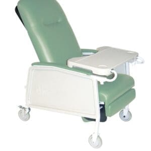A green reclining medical chair with four wheels and a foldable tray table. The chair has padded armrests and a high backrest for comfort, featuring a sturdy white frame.