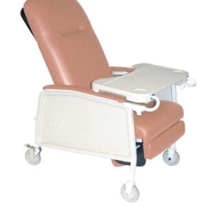 A beige reclining medical chair with a tray attached and four wheels for mobility. The chair has a cushioned seat and backrest, designed for patient comfort and support.