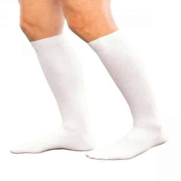 A pair of legs wearing knee-high white socks against a white background.