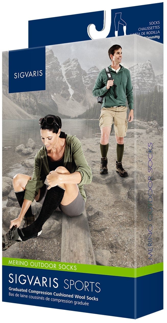 Packaging for Sigvaris Sports Merino Outdoor Socks. Image shows a man hiking and a woman adjusting her socks while seated on a rock. Background features a mountain landscape. Text highlights the socks graduated compression and wool material.