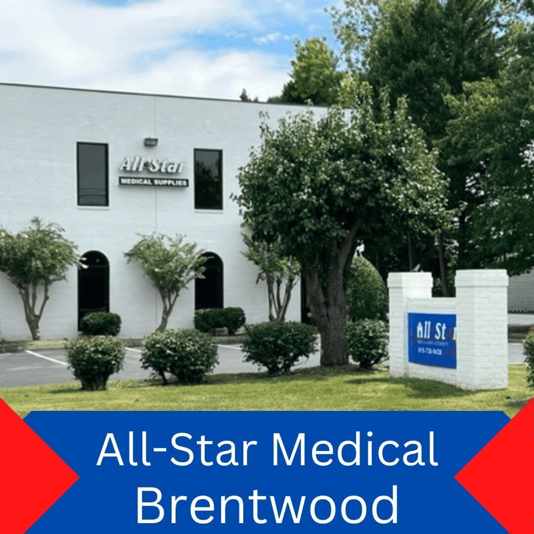 A white building with a sign reading All-Star Medical Supplies. Tall trees and shrubs surround the building. In the foreground, theres a blue and white sign with the text All Star Medical Brentwood and a phone number.