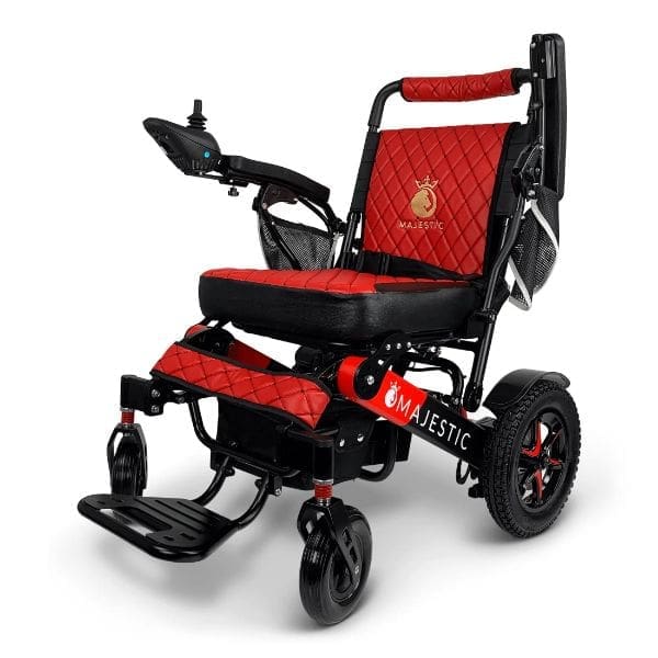Experience ultimate convenience with the red and black MAJESTIC IQ-7000, an auto-folding electric wheelchair featuring armrest joystick control, a comfortable padded seat, footrest, and swivel front wheels for effortless maneuverability.