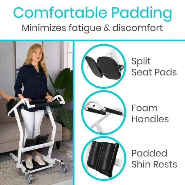 A person stands using a Transport Stand Assist with split seat pads and padded shin rests, highlighting comfortable padding, foam handles, and reduced fatigue. In the background, theres a plant near a sunlit window.