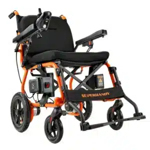 The SuperHandy Cares Portable Power Chair features a foldable electric design with an orange and black frame, padded armrests, left-side control joystick, and sturdy wheels. SUPERHANDY is prominently displayed on the footrest.